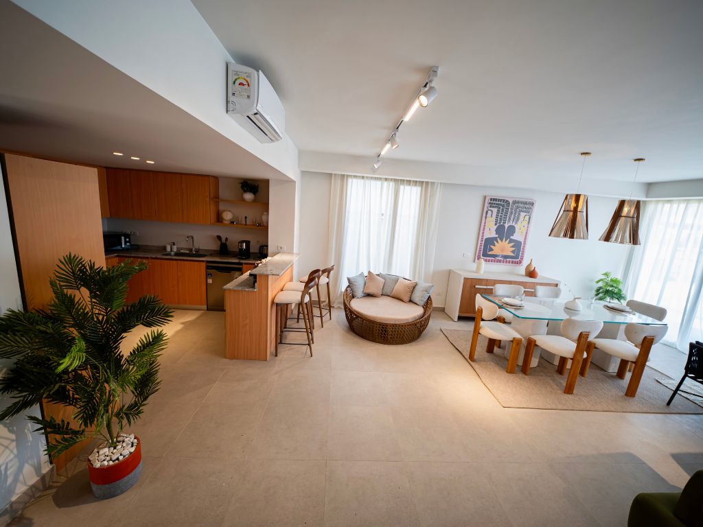 Kitchen, dining and sitting zones in an iL Bayou Laguna furnished interior