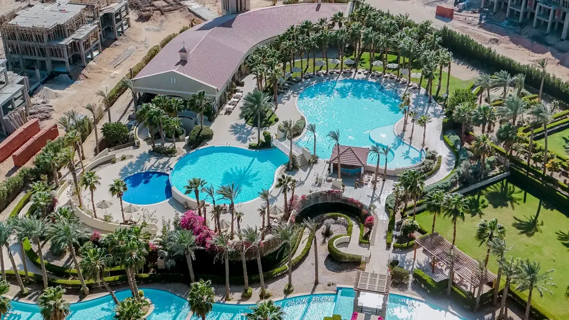 Aerial view of swimming pools, lawns and palms at Veranda in Sahl Hasheesh
