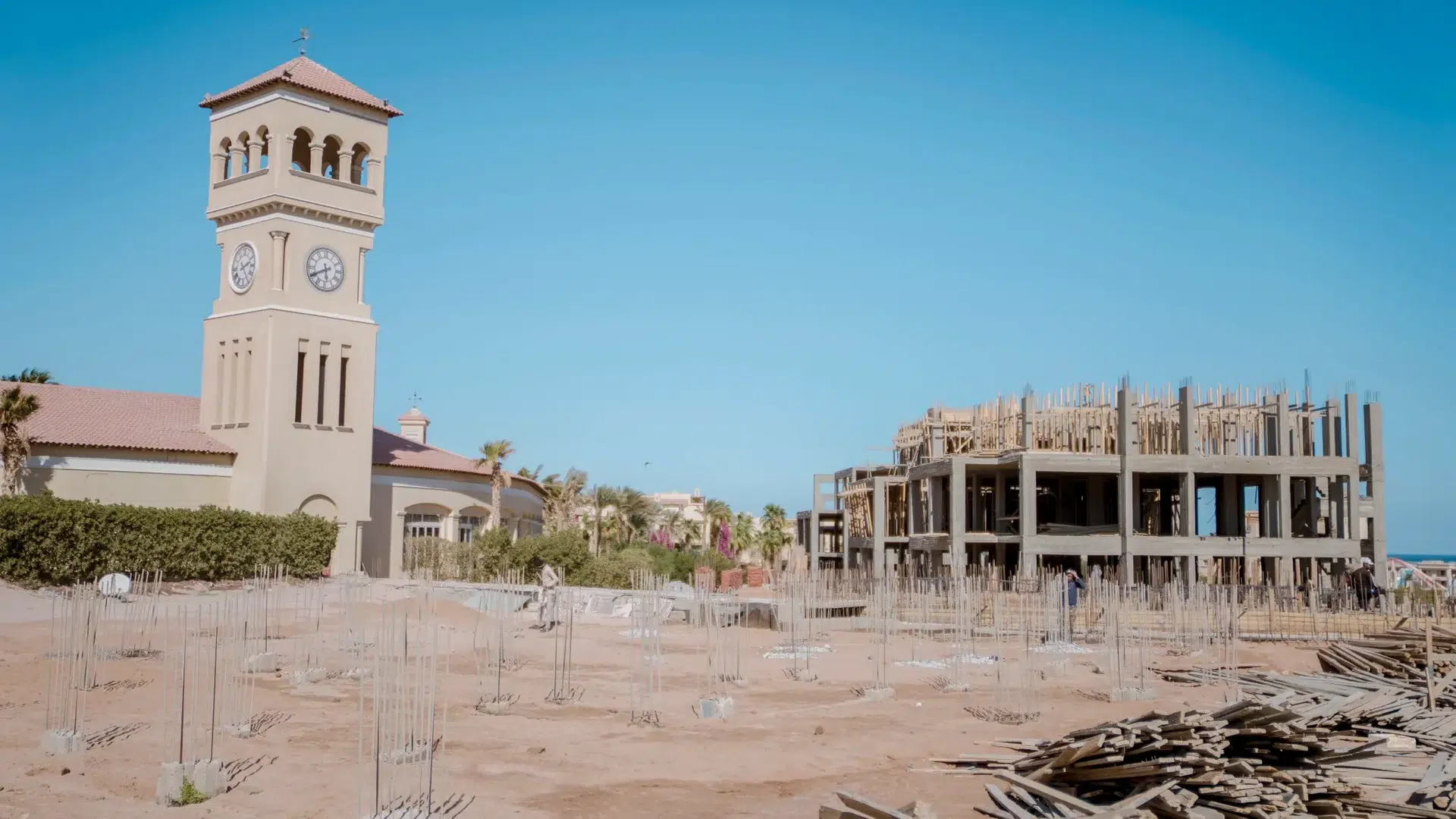 Ground-level view of a tower and buildings under construction at Veranda in Sahl Hasheesh