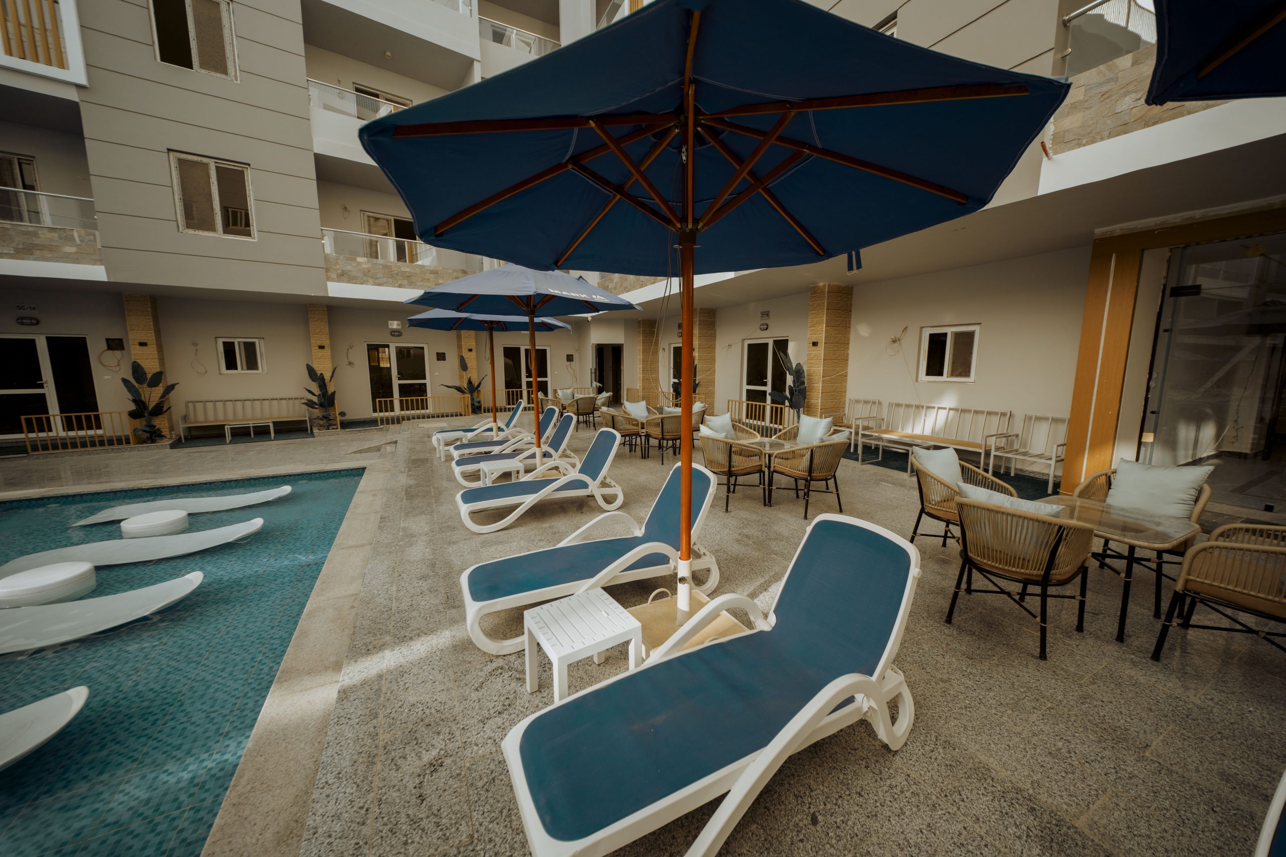 Poolside loungers and blue parasols at Mark Resort, Hurghada