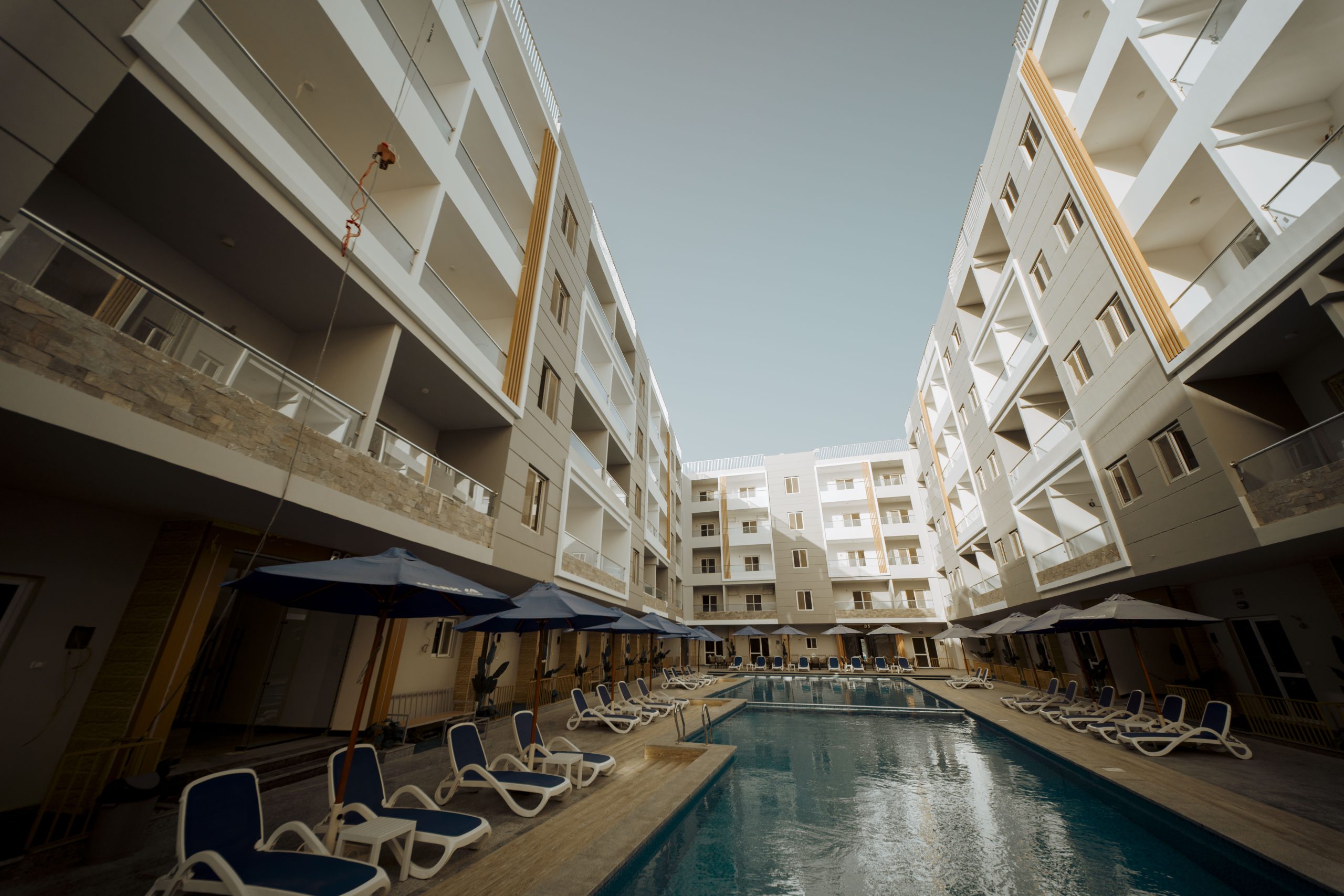 Mark Resort apartment balconies rising above the courtyard swimming pool