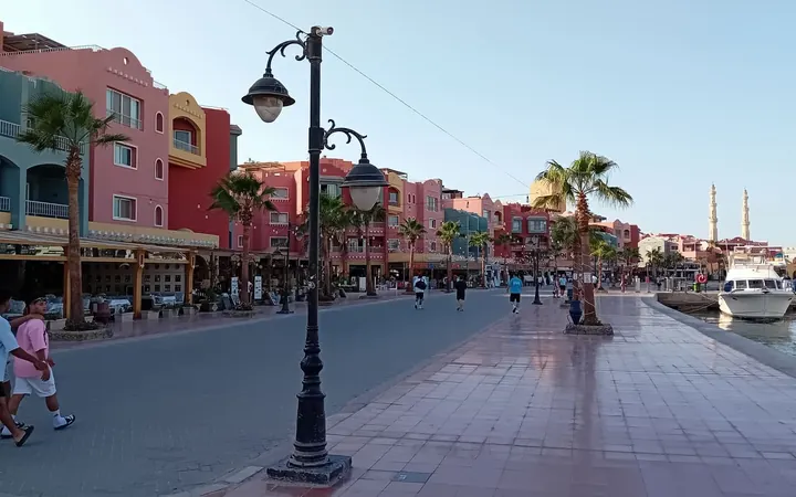 Boats moored at Hurghada Marina beside colourful waterfront buildings