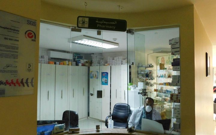 Glass-fronted pharmacy entrance and medicine shelves at Nile Hospital in Hurghada