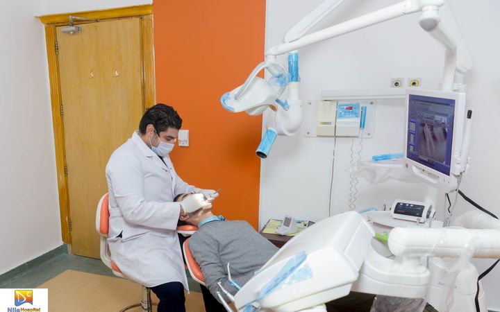 Dentist and patient beside dental equipment at Nile Dental Center in Hurghada