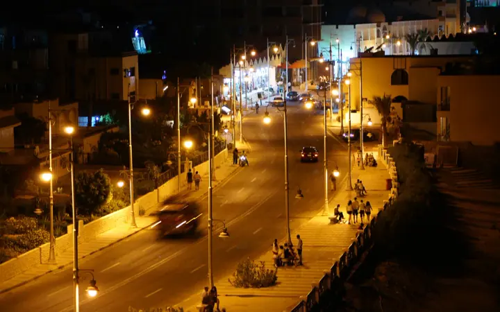 Streetlights, buildings and pedestrians on Sheraton Road in Hurghada at night