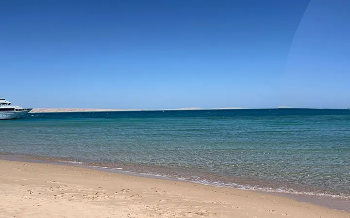 Sandy shoreline and clear Red Sea water in Hurghada